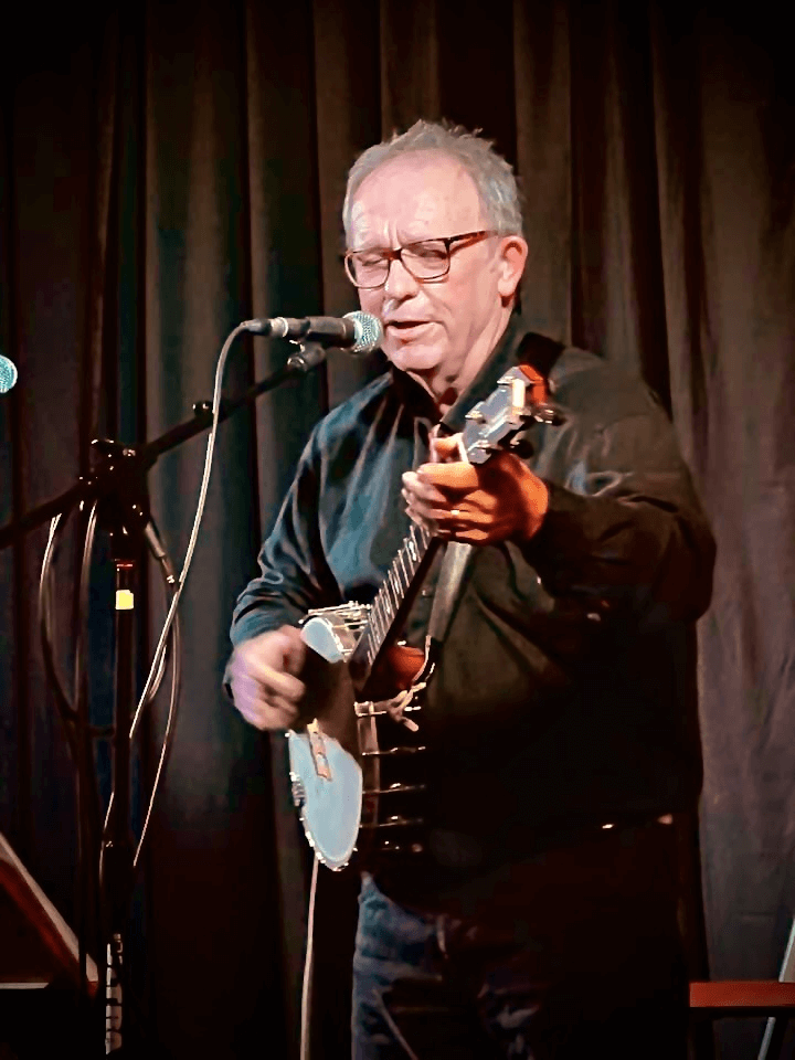 Arthur McGregor - Distinguished older gentleman with glasses performing with a ukulele